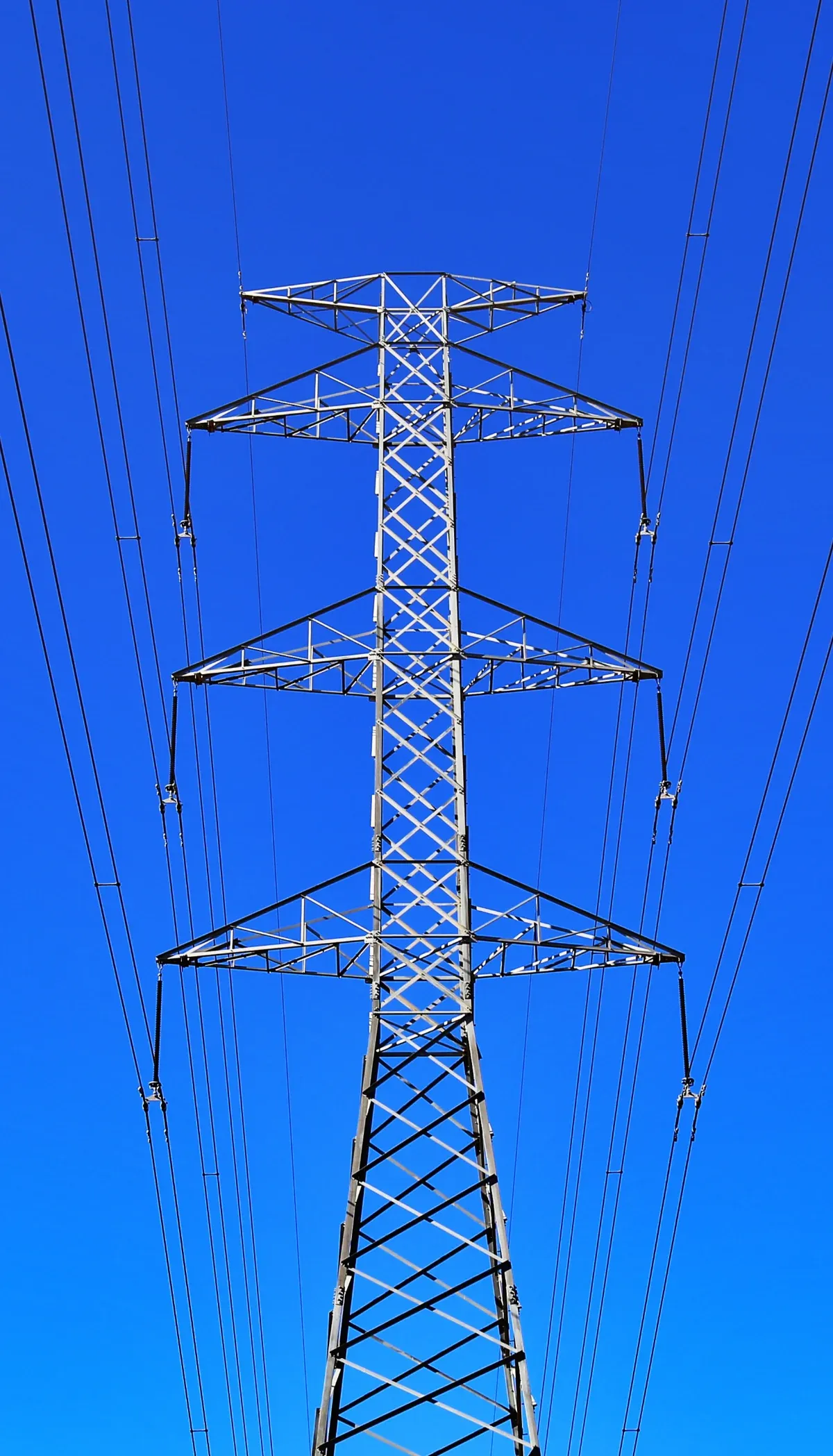 High-voltage transmission tower against a blue sky